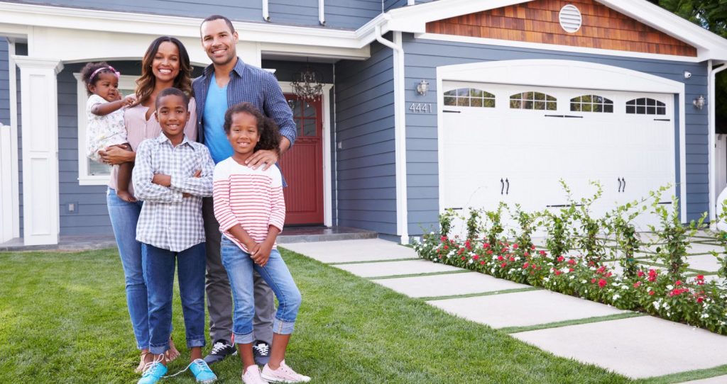 Family in front of FHA 203(k) home