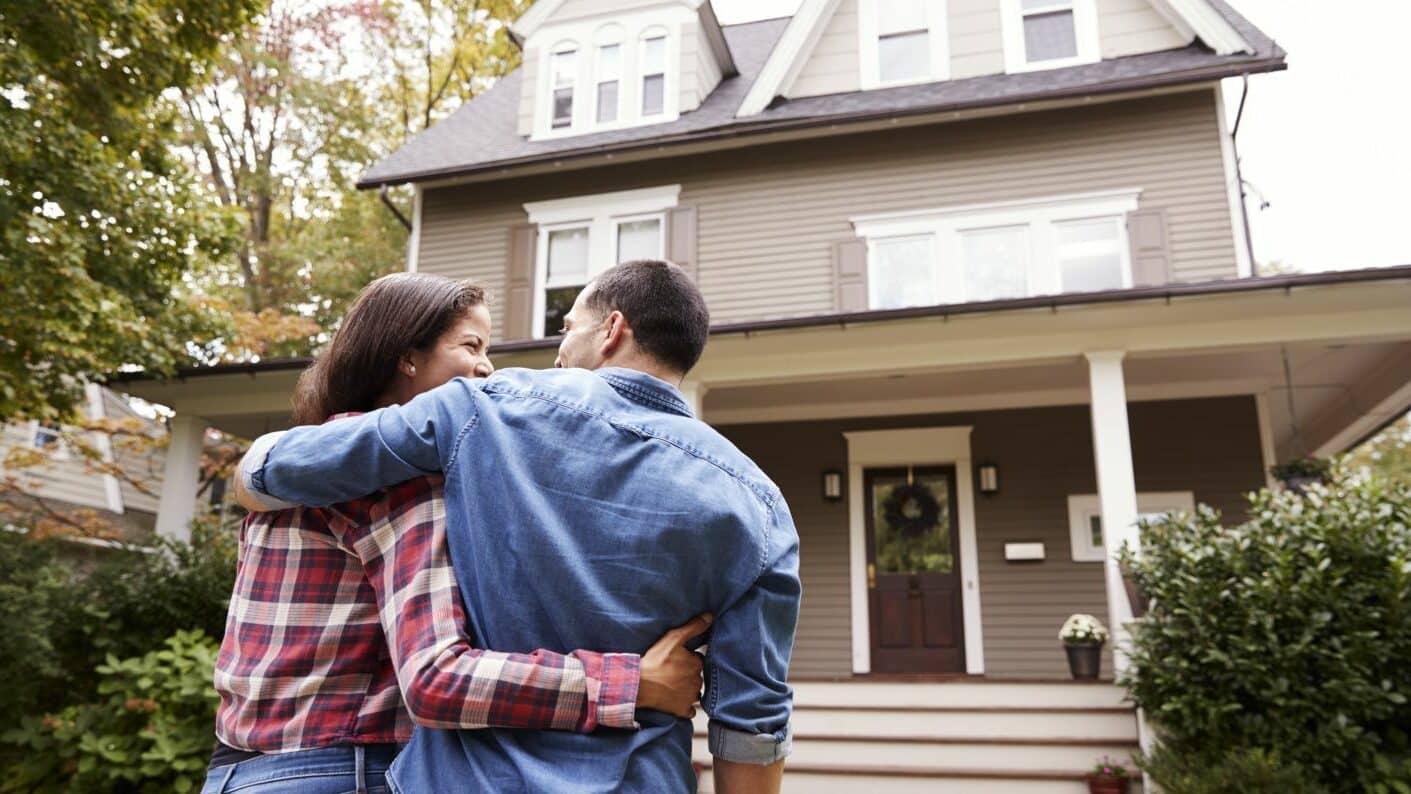 Couple in front of home