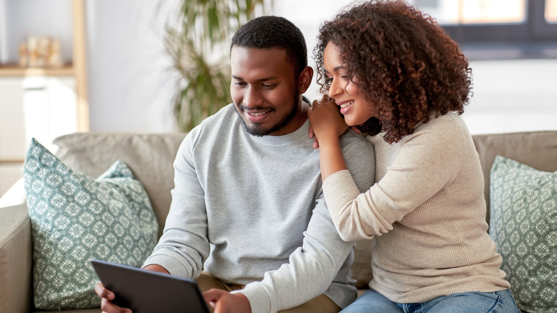 Couple looking at their new home on Zillow