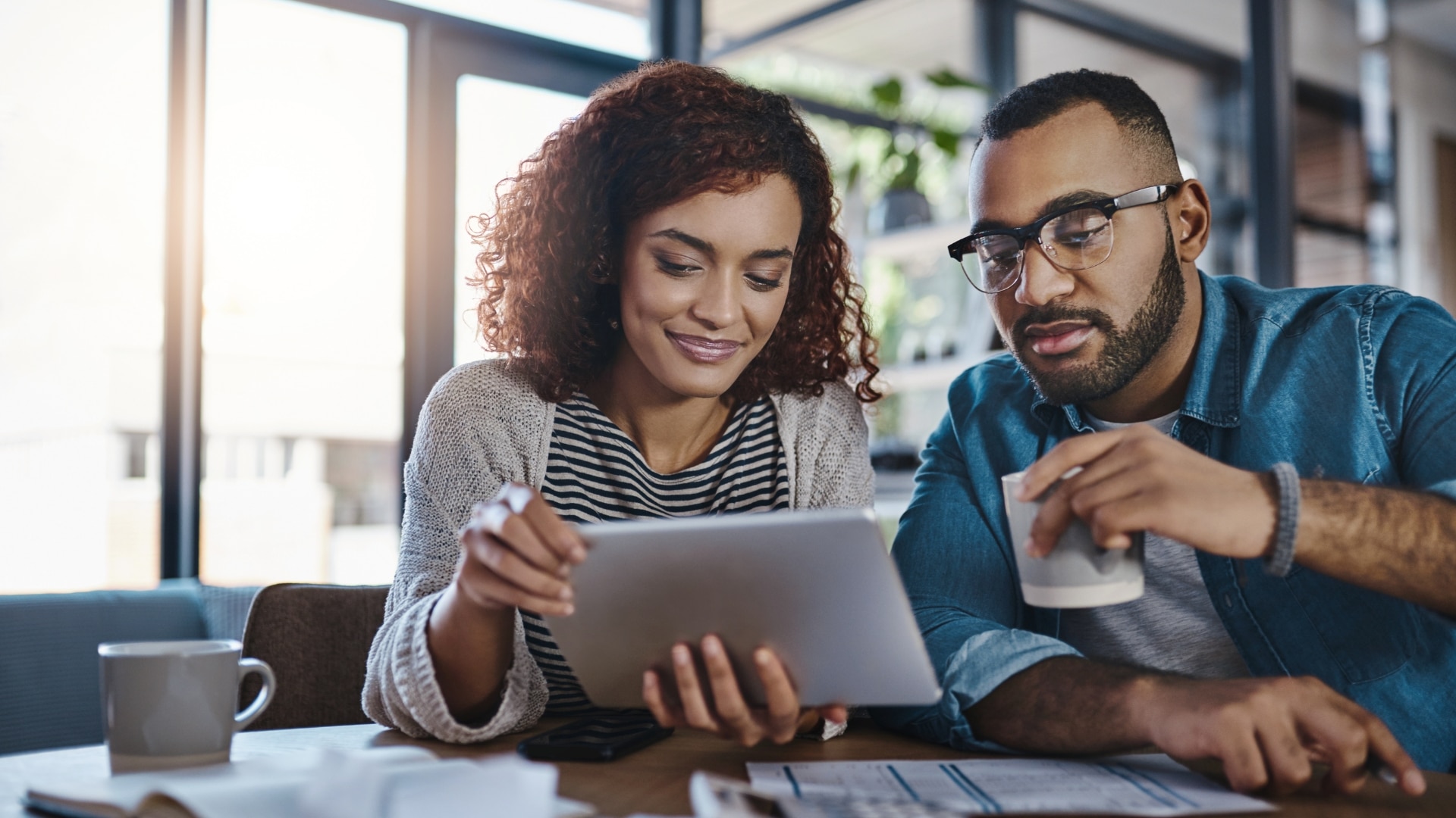 Couple reviewing tips for improving their credit scores on koloans.com